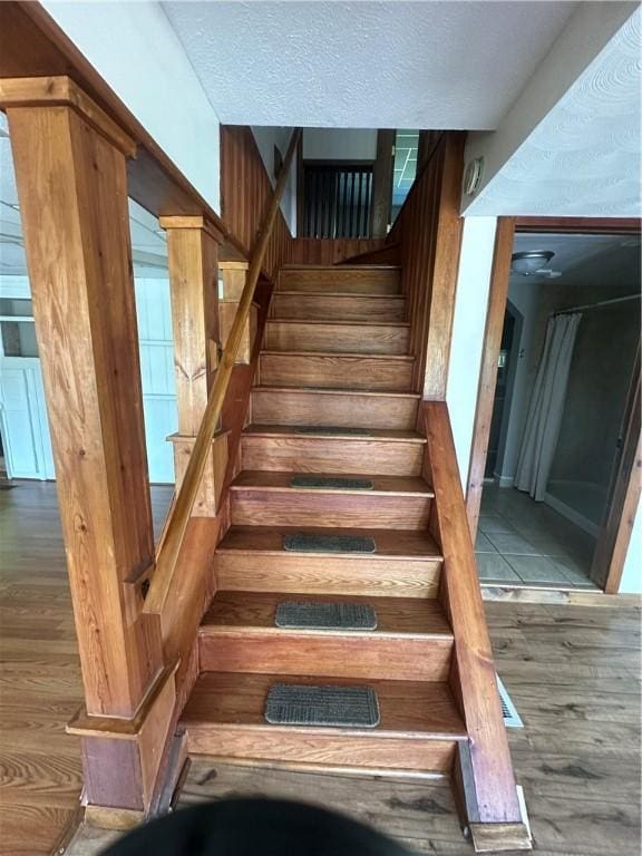 staircase featuring wood-type flooring