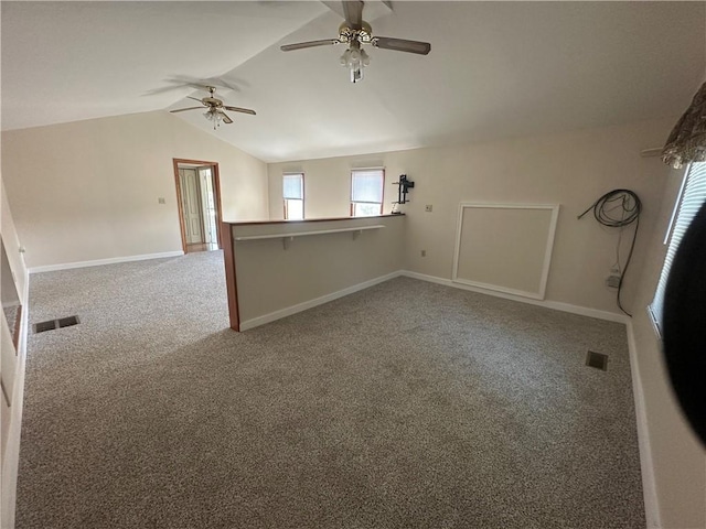 unfurnished room with carpet, ceiling fan, and vaulted ceiling