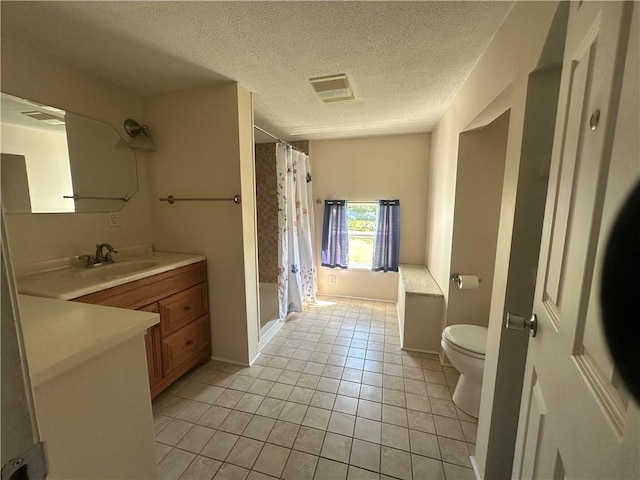 bathroom with walk in shower, tile patterned flooring, a textured ceiling, toilet, and vanity