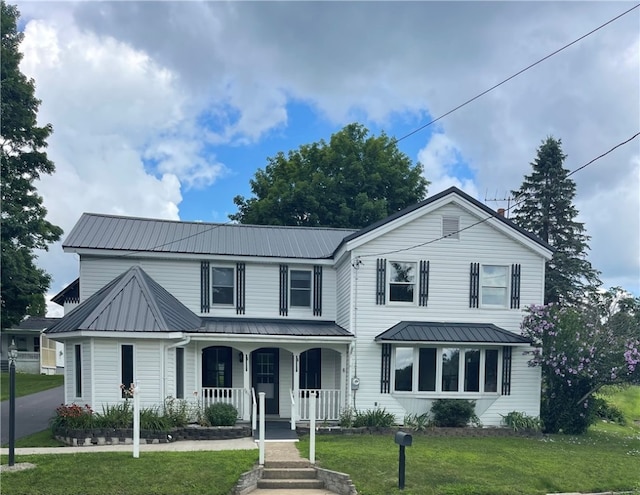 view of front of home with covered porch and a front lawn