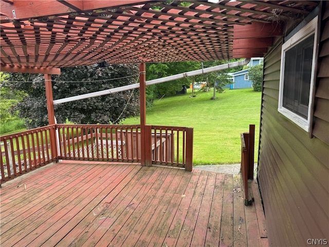 wooden terrace featuring a pergola and a yard