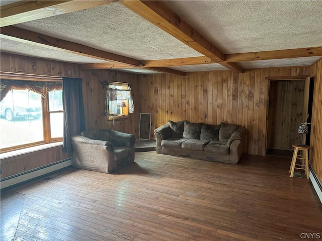 living room featuring a textured ceiling, wood walls, beam ceiling, wood-type flooring, and a baseboard radiator