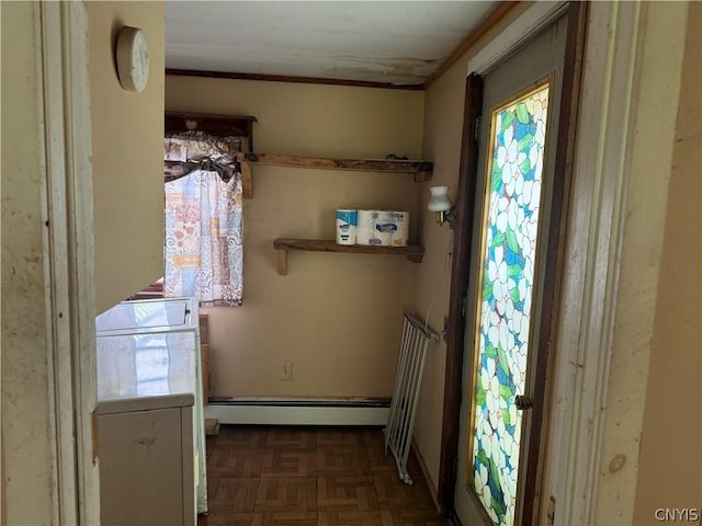 doorway featuring ornamental molding, independent washer and dryer, plenty of natural light, and baseboard heating