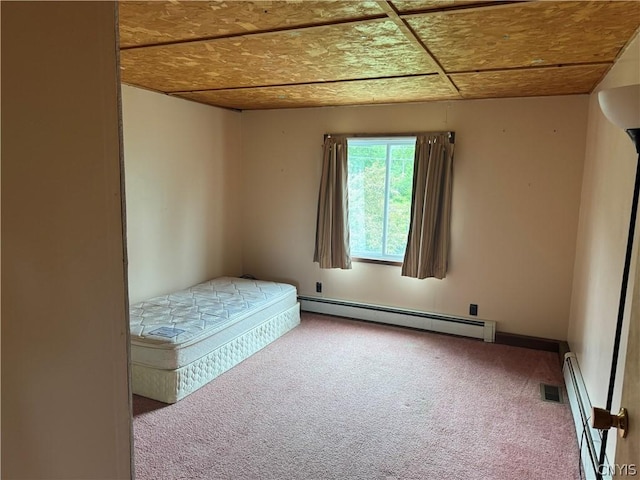 unfurnished bedroom featuring carpet flooring and a baseboard radiator