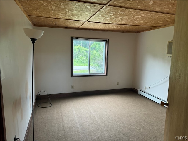 unfurnished room featuring baseboard heating and carpet