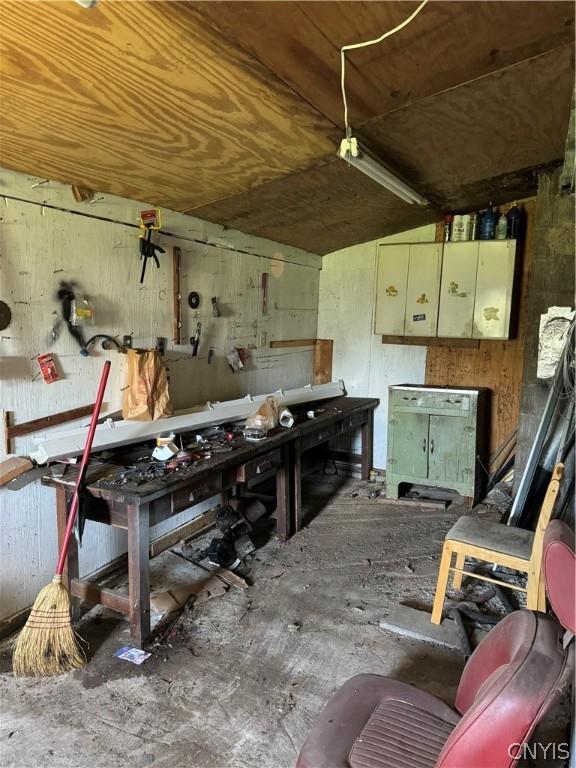 miscellaneous room featuring a workshop area and lofted ceiling