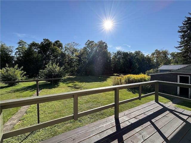 wooden deck with a lawn