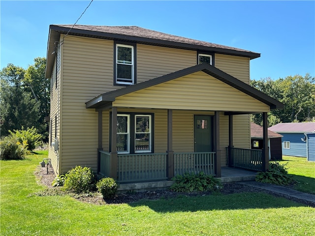 view of front facade with a front yard and a porch