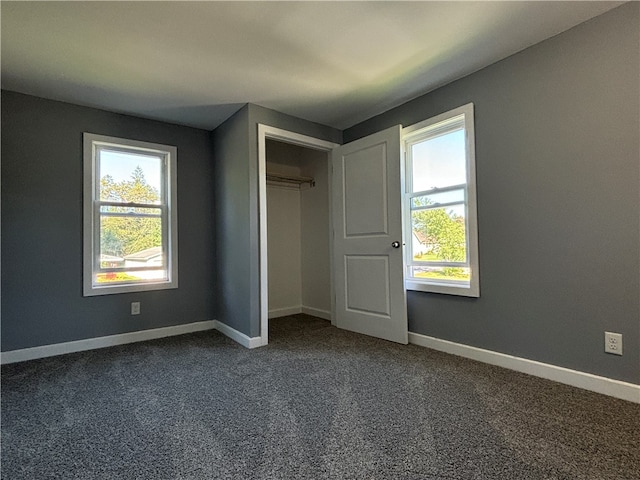 unfurnished bedroom with a closet and carpet