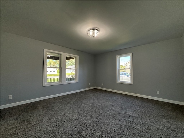 carpeted empty room featuring a wealth of natural light