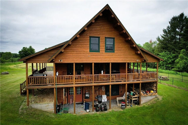 rear view of house featuring a yard, a patio, and a deck