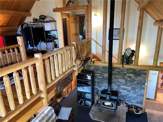 misc room with vaulted ceiling with beams, a wood stove, and wood ceiling