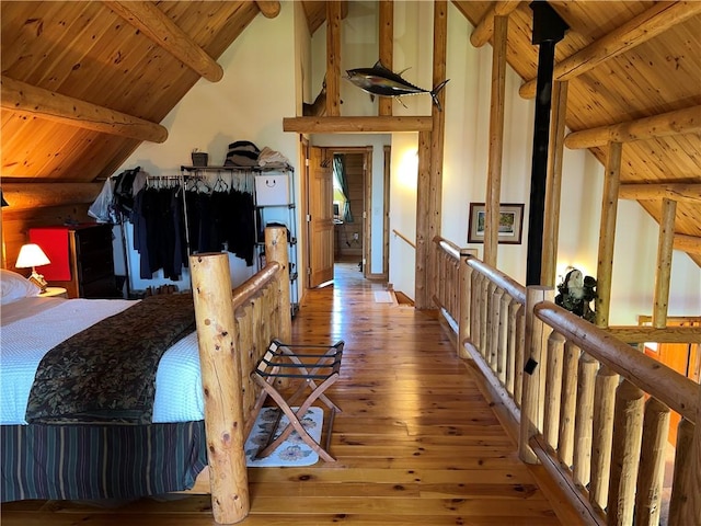 interior space with vaulted ceiling with beams, wooden ceiling, and hardwood / wood-style flooring