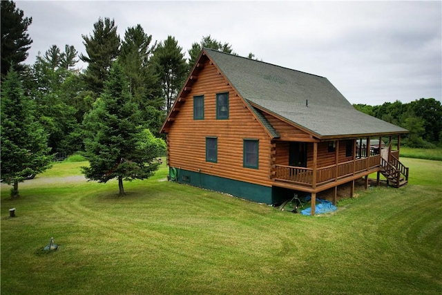 rear view of house featuring a lawn