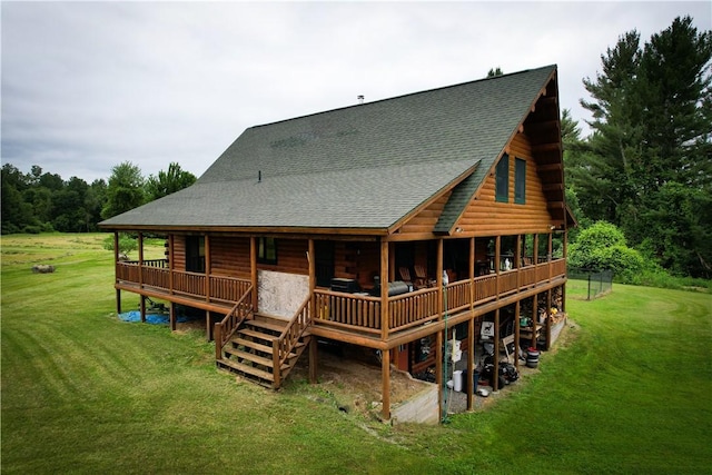 back of property with a deck and a lawn