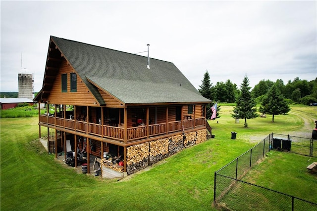 back of property with a lawn and a wooden deck