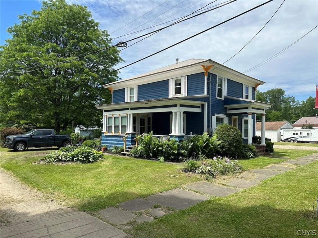 221 W Main St, Angelica, NY 14709 - traditional style home featuring a front lawn and a porch