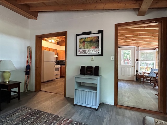 interior space featuring wood-type flooring, vaulted ceiling with beams, and ceiling fan