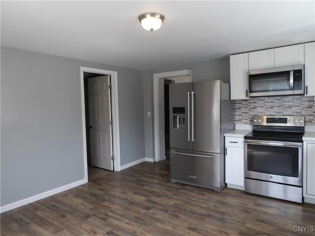 kitchen featuring stainless steel appliances, white cabinets, light countertops, and decorative backsplash
