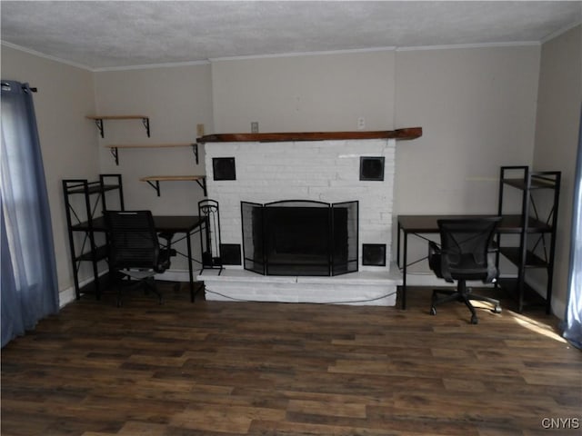living room with crown molding, wood finished floors, a brick fireplace, and a textured ceiling