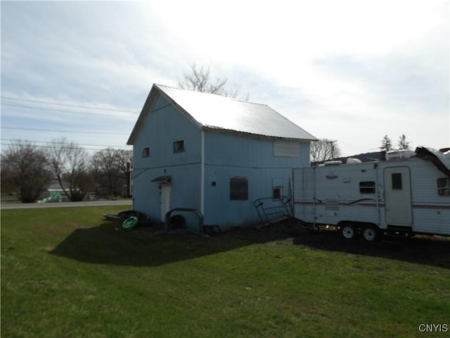 view of home's exterior with a yard and metal roof