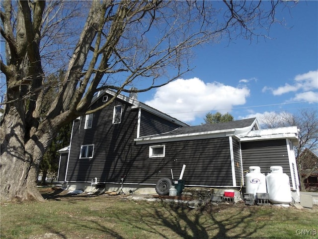 view of home's exterior with a yard