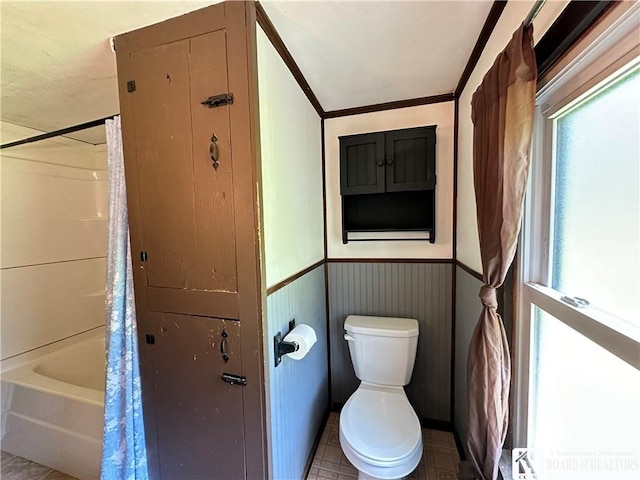 bathroom featuring tile patterned floors, toilet, ornamental molding, and shower / tub combo