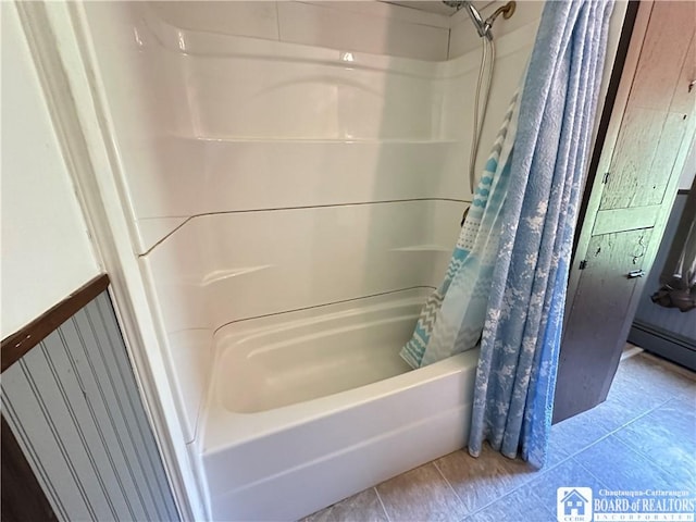 bathroom featuring tile patterned flooring and shower / bath combo with shower curtain