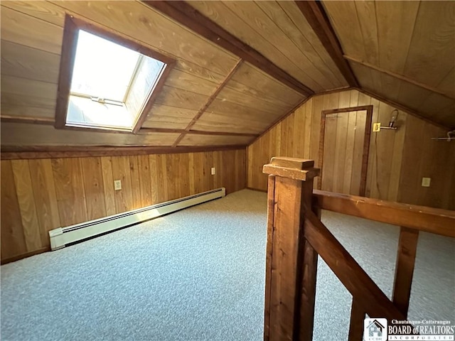 additional living space with carpet flooring, vaulted ceiling with skylight, wooden ceiling, and a baseboard heating unit