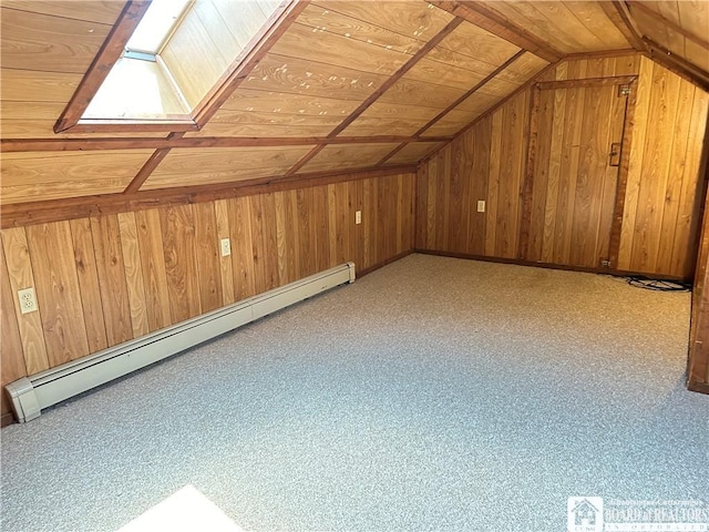 additional living space with wood walls, lofted ceiling with skylight, baseboard heating, and wooden ceiling