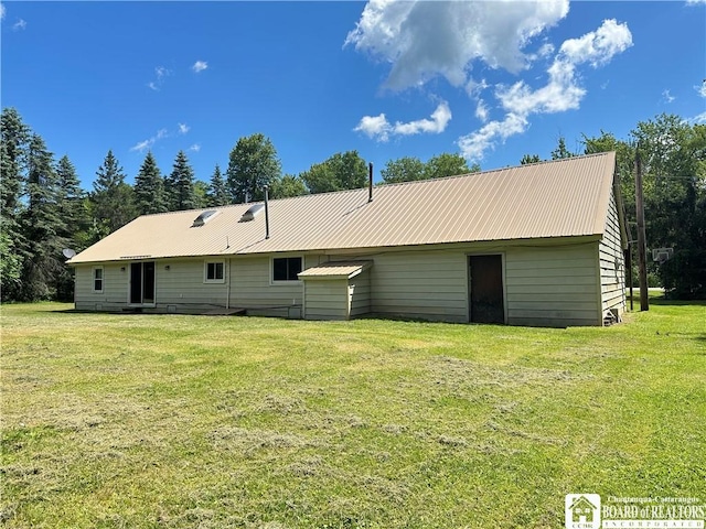 back of property featuring a lawn