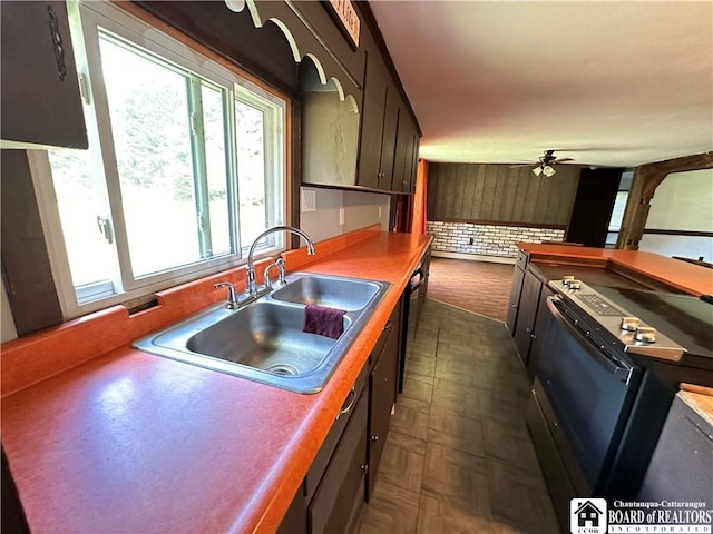 kitchen featuring black dishwasher, ceiling fan, range with electric stovetop, and sink