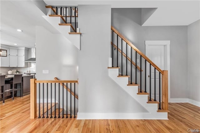 stairway featuring hardwood / wood-style floors