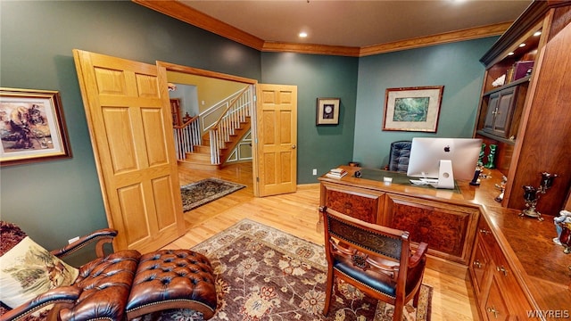 office space with light wood-style floors and ornamental molding