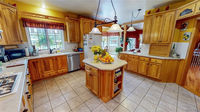 kitchen with white appliances, light tile patterned floors, light countertops, and a sink