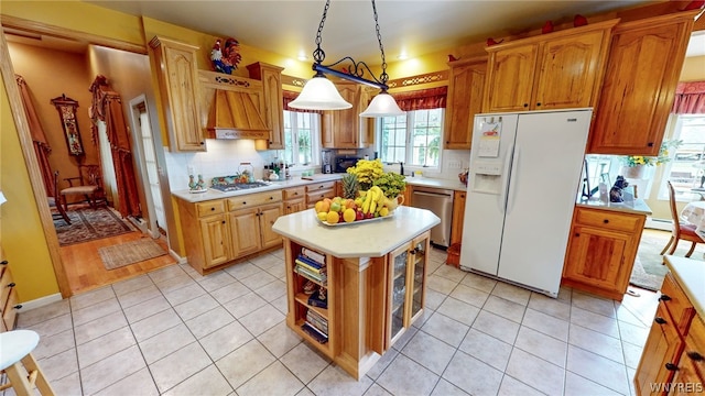 kitchen featuring decorative light fixtures, light tile patterned floors, light countertops, white fridge with ice dispenser, and dishwasher