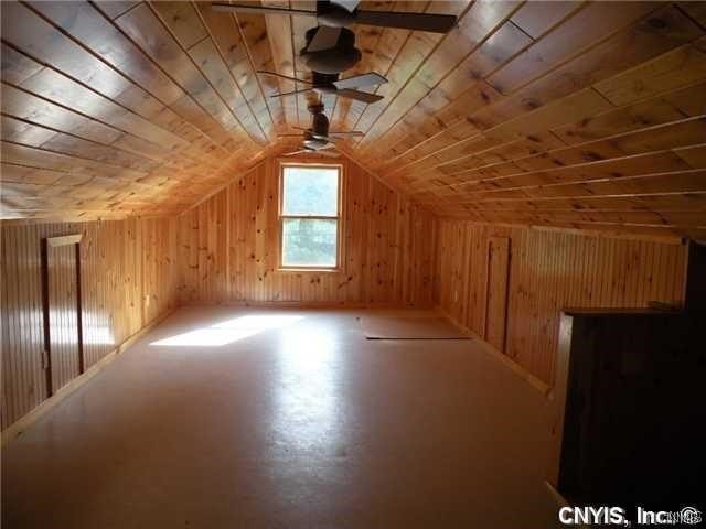 bonus room featuring ceiling fan, vaulted ceiling, and wooden ceiling