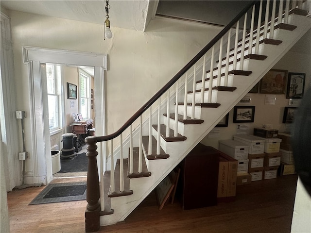 stairway with hardwood / wood-style flooring