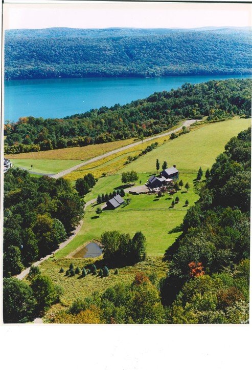 birds eye view of property featuring a water view and a rural view