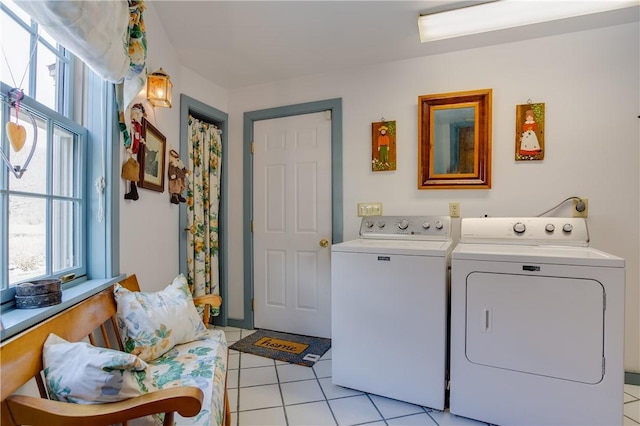 laundry room with light tile patterned floors and washer and dryer