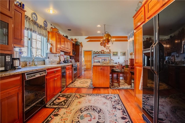 kitchen with a kitchen bar, sink, dishwasher, beverage cooler, and light hardwood / wood-style floors