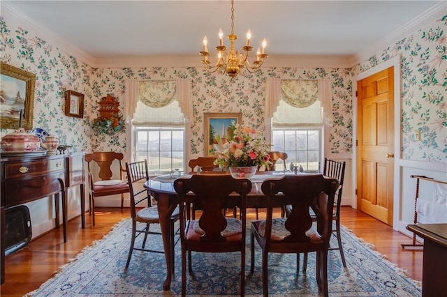 dining area featuring hardwood / wood-style flooring, crown molding, and a chandelier