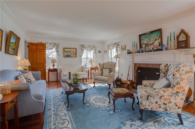 living room with hardwood / wood-style flooring, ornamental molding, and a brick fireplace