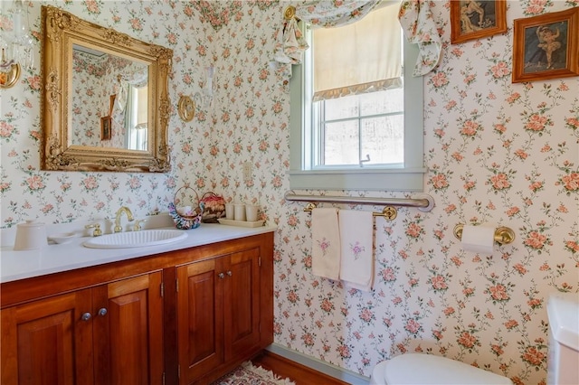 bathroom featuring vanity and toilet