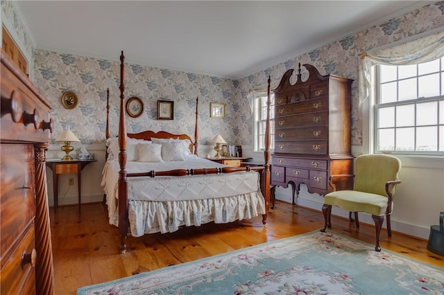 bedroom featuring ornamental molding and hardwood / wood-style floors