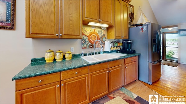 2638 Shadyside Rd, Mina, NY 14736 - kitchen featuring light wood finished floors, a sink, dark countertops, brown cabinets, and stainless steel fridge with ice dispenser