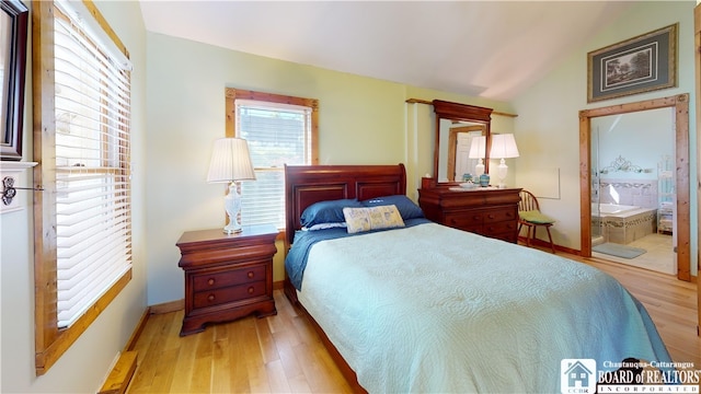 2638 Shadyside Rd, Mina, NY 14736 - bedroom with ensuite bath, vaulted ceiling, wood finished floors, and baseboards