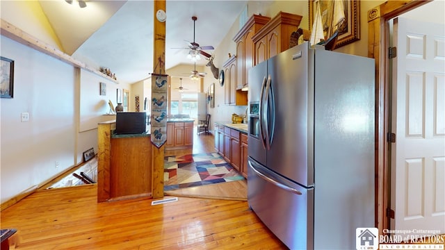 2638 Shadyside Rd, Mina, NY 14736 - kitchen with brown cabinets, vaulted ceiling, a ceiling fan, light wood-type flooring, and stainless steel refrigerator with ice dispenser
