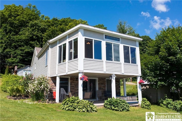 2638 Shadyside Rd, Mina, NY 14736 - view of front of house featuring a sunroom, stone siding, a front yard, and covered porch