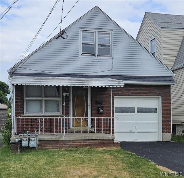 view of front of house with a garage and a front lawn